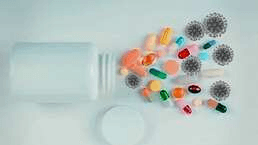 Pills beside a medicine bottle